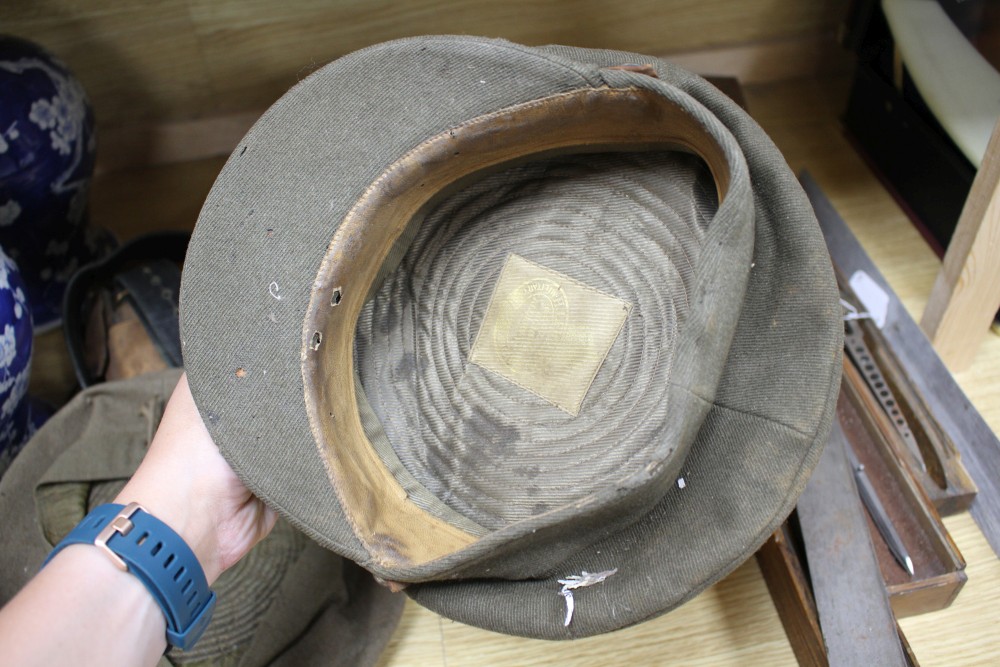 A WWII steel helmet, a Royal Gloucestershire Hussars cap, a Scots Guards? cap, three leather items and a Union Jack